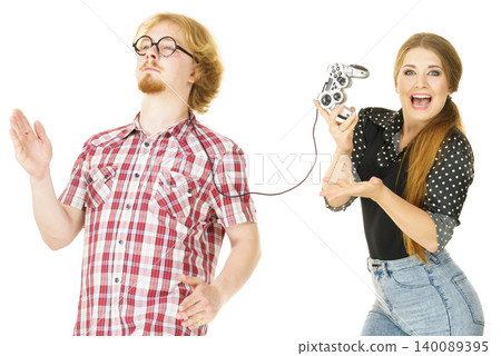 Woman controling man using gaming pad 140089395