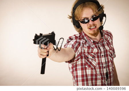 Gamer man shooting from gun Gamer man shooting from gun 140089396