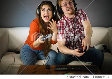 Gamer couple playing games Gamer couple playing games 140089397