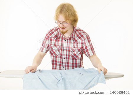 Man about to do ironing Man about to do ironing 140089401