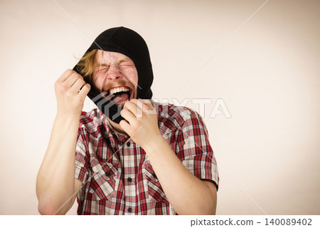 Sad man wearing balaclava 140089402
