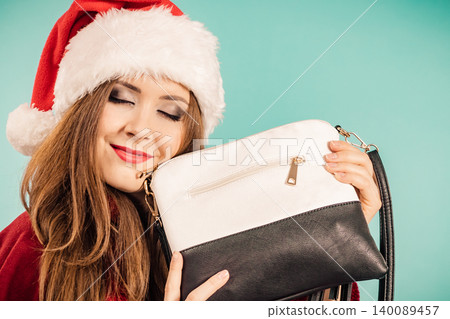 Christmas girl holding handbag present 140089457
