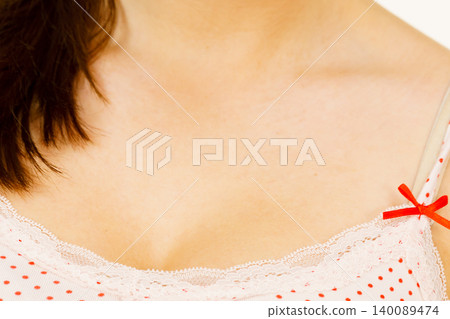 Woman in underwear shirt showing her neckline Woman in underwear shirt showing her neckline 140089474