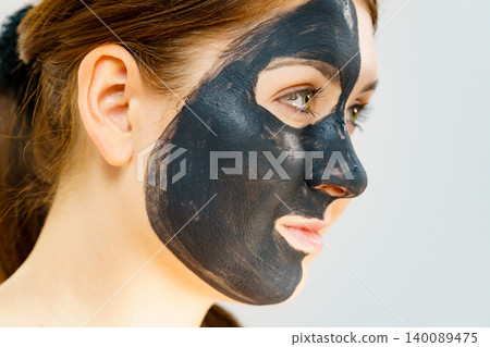 Woman with charcoal facial mask Woman with charcoal facial mask 140089475