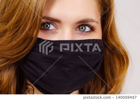 Woman using protective face mask. Woman using protective face mask. 140089487