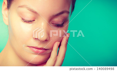 Woman in facial peel off mask. Woman in facial peel off mask. 140089498