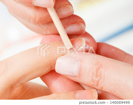 Preparing nails before manicure, pushing back cuticles Preparing nails before manicure, pushing back cuticles 140089499
