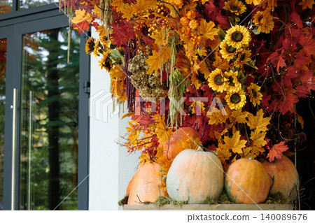 Autumnal town house porch decorated with pumpkins and fall foliage for Thanksgiving Autumnal town house porch decorated with pumpkins and fall foliage for Thanksgiving 140089676