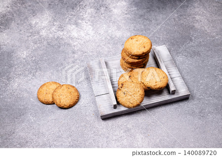 Homemade oatmeal cookies on rustic wooden tray Homemade oatmeal cookies on rustic wooden tray 140089720