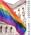 Rainbow pride flag waves in front of historic city building. Concept of LGBTQ rights 140090198
