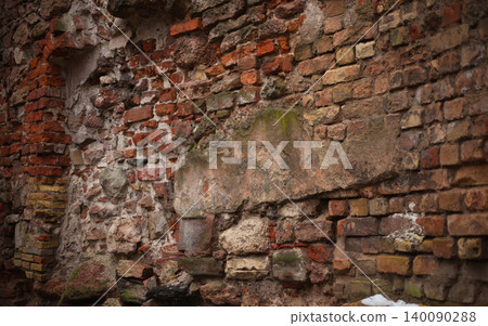 Detailed close-up of a rustic, heavily weathered ancient brick wall with a large patch of mossy Detailed close-up of a rustic, heavily weathered ancient brick wall with a large patch of mossy 140090288