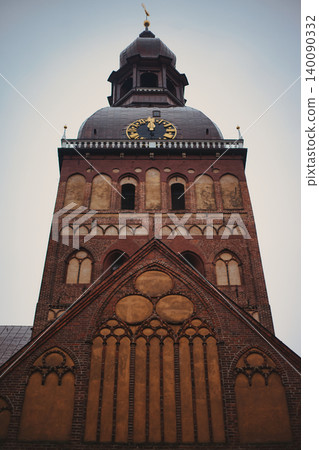 Low-angle view of a majestic medieval red brick cathedral 140090332