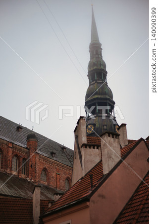 Medieval Church Spire with Clock Tower Rising Above Medieval Church Spire with Clock Tower Rising Above 140090399