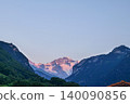 Alpine Glow on Snow-Capped Peak at Dawn 140090856