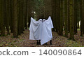 Two Playful Ghosts in a Spooky Pine Forest. Halloween costumes 140090864