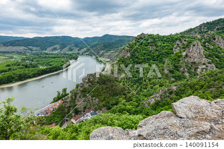 The Danube river flowing through the Wachau Valley surrounded by rocky hills, symbolizing adventure and outdoor exploration. The Danube river flowing through the Wachau Valley surrounded by rocky hills, symbolizing adventure and outdoor exploration. 140091154