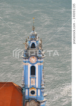 Parish and Collegiate Church of the Assumption of Mary in Durnstein by the Danube river showing historic architecture. Parish and Collegiate Church of the Assumption of Mary in Durnstein by the Danube river showing historic architecture. 140091195