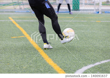 Man kicking a soccer ball Man kicking a soccer ball 140091637