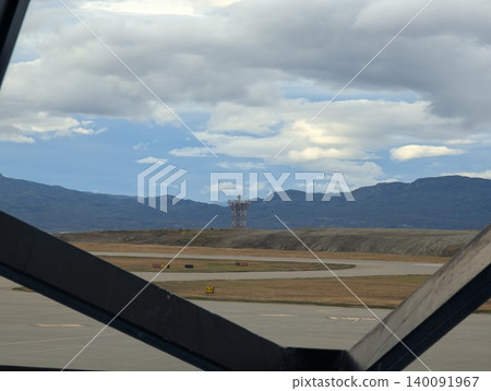 Ushuaia, Tierra del Fuego, Argentina - March 9, 2026: Runway and mountain landscape viewed from the airport terminal 140091967