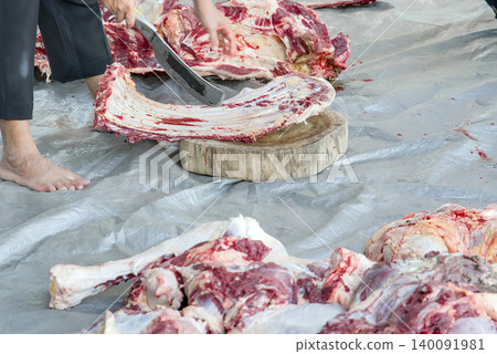 butcher cutting meat in the market butcher cutting meat in the market 140091981
