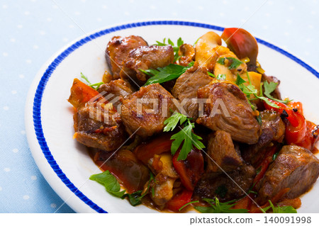 Meat baked with mushrooms and vegetables Meat baked with mushrooms and vegetables 140091998