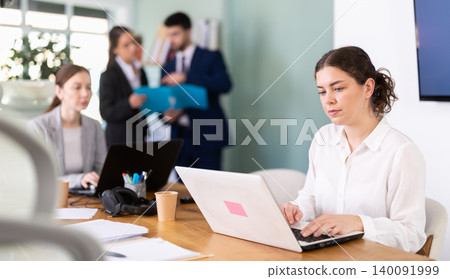Young woman is a qualified specialist, works in a modern office 140091999