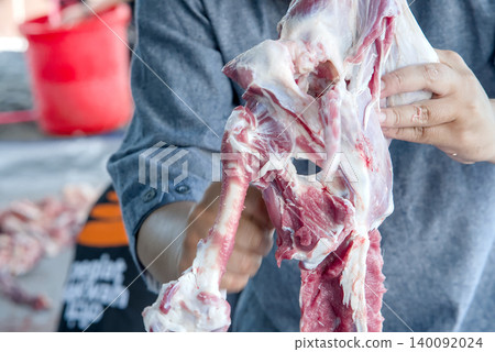 Fresh raw pork ribs cut into pieces on a textured surface Fresh raw pork ribs cut into pieces on a textured surface 140092024