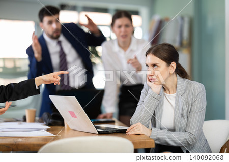 Angry office employees shout at a guilty employee who made mistakes in the project 140092068