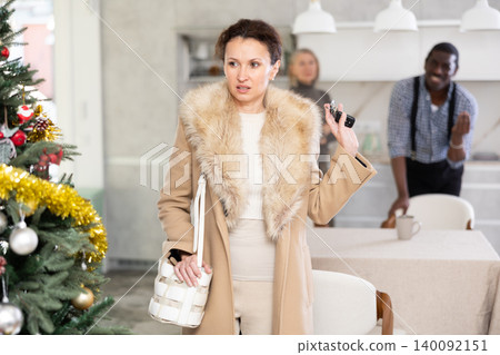 Dissatisfied woman leaves her husband and mother during Christmas celebration 140092151