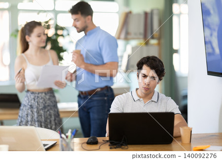 Man staff working at laptop computer in office room space Man staff working at laptop computer in office room space 140092276