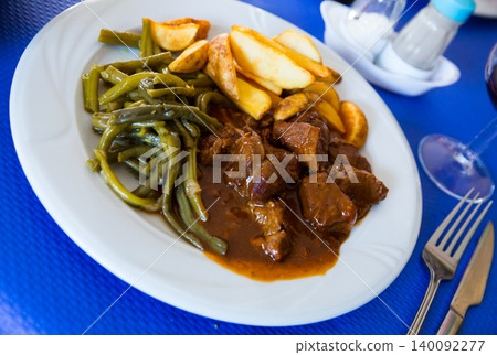 Stewed beef with vegetable garnish 140092277