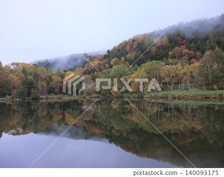Autumn foliage reflection at Kidoike Pond in Shiga Kogen Autumn foliage reflection at Kidoike Pond in Shiga Kogen 140093175