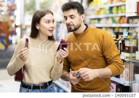 Young couple chooses perfume in store Young couple chooses perfume in store 140093187