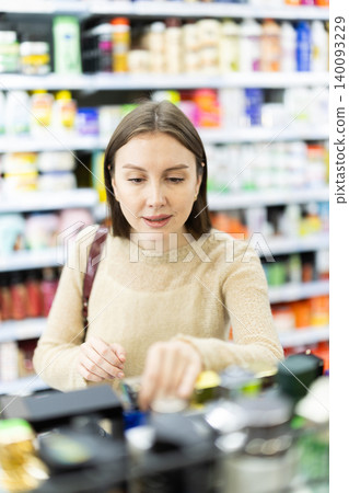Woman spends time in store, looking for goods and select perfume 140093229