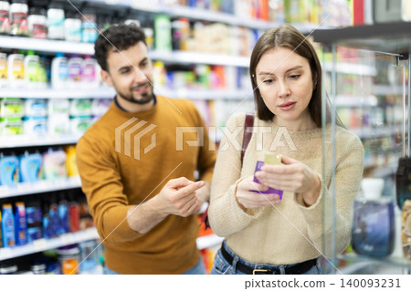 Young couple chooses perfume in store 140093231