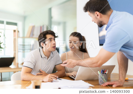 Girl and two men office staff talk and discuss working issues, discuss document papers Girl and two men office staff talk and discuss working issues, discuss document papers 140093300