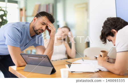 Tired office workers having nap while sitting in workplace Tired office workers having nap while sitting in workplace 140093335
