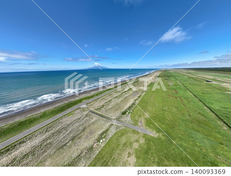 Aerial photograph of Sarobetsu Coast and a straight road overlooking Mount Rishiri, Wakkanai City, Hokkaido. Aerial photograph of Sarobetsu Coast and a straight road overlooking Mount Rishiri, Wakkanai City, Hokkaido. 140093369