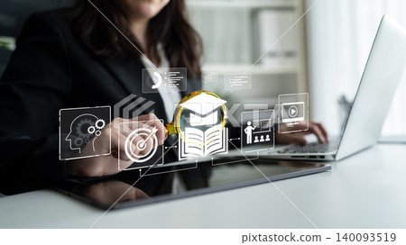 Businesswoman using laptop with digital education icons and holographic interface for online learning and professional development in modern office setting. Bitwise 140093519