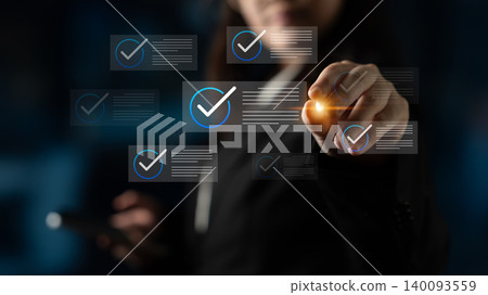 Business professional interacting with digital checklist on screen to signify completion and success in a modern workspace setting Cyphers. Business professional interacting with digital checklist on screen to signify completion and success in a modern workspace setting Cyphers. 140093559