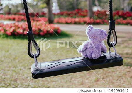 Teddy bear sitting on swing in park garden, concept for broken heart, missing childhood, loneliness sad. Teddy bear sitting on swing in park garden, concept for broken heart, missing childhood, loneliness sad. 140093642