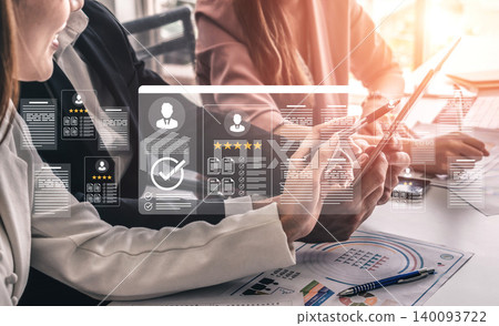 Business Partners Collaborating with Digital Technology and Online Data Presentation for Effective Decision Making in a Modern Office Environment Ledger 140093722