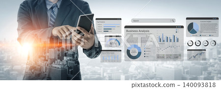 Business Professional Analyzing Data on Tablet While Surrounded by Digital Graphics, Charts, and Business Reports in Modern Urban Environment Ledger 140093818