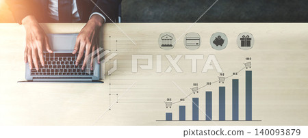 Professional hands typing on laptop with financial growth chart and icons representing banking, shopping, and gifting concepts in a modern office setting Quark 140093879