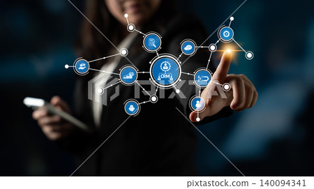 Businesswoman Interacting with Digital Network Interface and CRM Icons for Modern Marketing Solutions in a Professional Office Setting. Tessel Businesswoman Interacting with Digital Network Interface and CRM Icons for Modern Marketing Solutions in a Professional Office Setting. Tessel 140094341