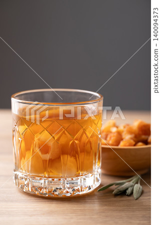 Longan juice in glass with dried longan fruit on wooden background Longan juice in glass with dried longan fruit on wooden background 140094373