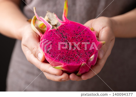 Fresh red dragon fruit holding by woman hand, Tropical fruit in summer season Fresh red dragon fruit holding by woman hand, Tropical fruit in summer season 140094377
