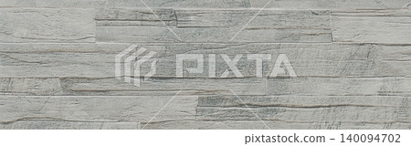 Weathered wood texture simulating stacked rustic timber planks with a grey gradient and rough grain 140094702