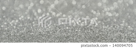 Silver glitter background displaying sparkling bokeh lights and shiny particles Silver glitter background displaying sparkling bokeh lights and shiny particles 140094705