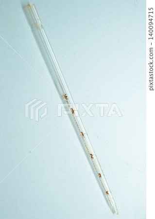 Glass volumetric pipette displaying precise markings for accurate liquid measurement, essential for scientific experiments, chemical analysis, and laboratory work Glass volumetric pipette displaying precise markings for accurate liquid measurement, essential for scientific experiments, chemical analysis, and laboratory work 140094715